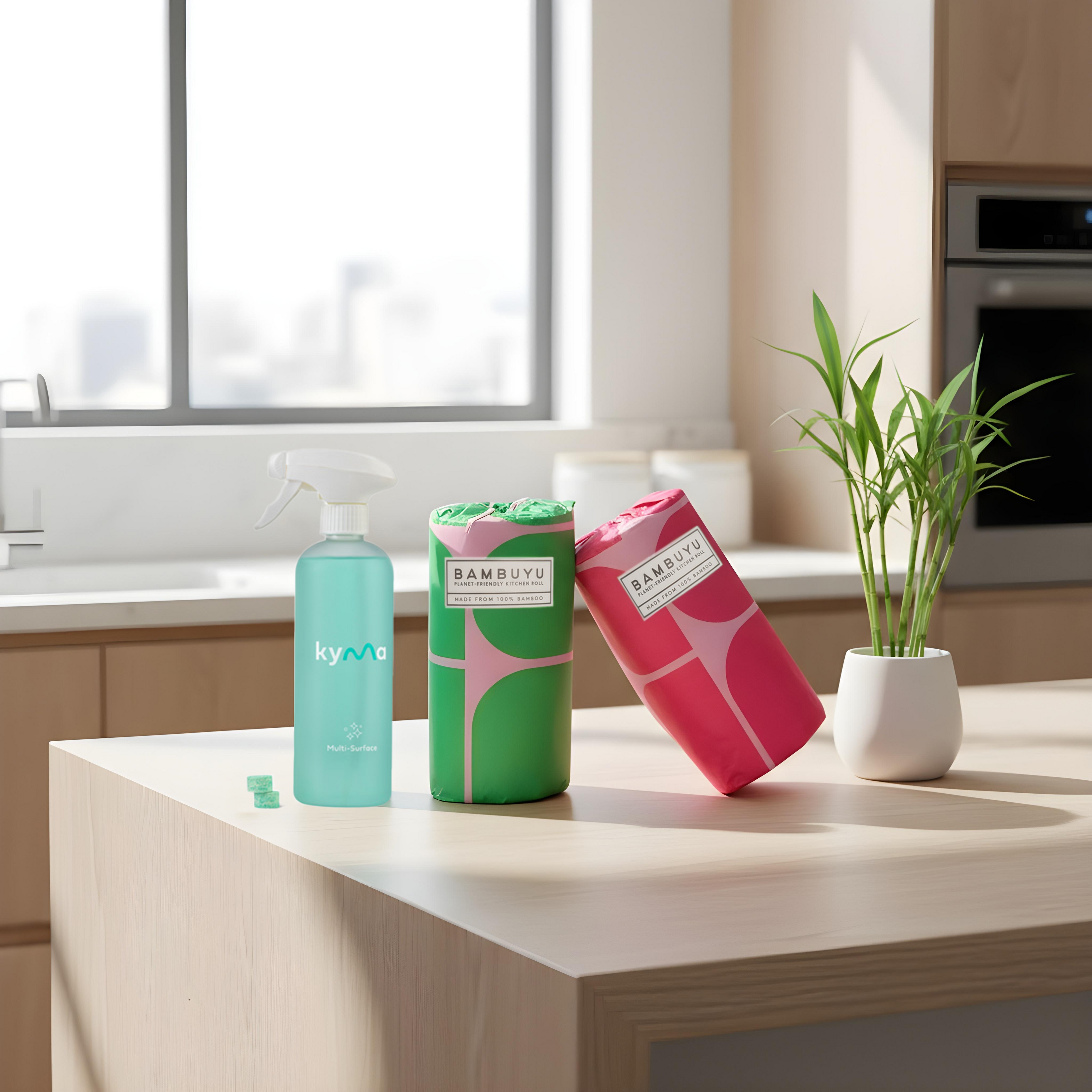 Kyma × Bambuyu The Clean Pair set with Kyma multi-surface cleaner and Bambuyu reusable towels on a kitchen counter. The eco-friendly home cleaning kit