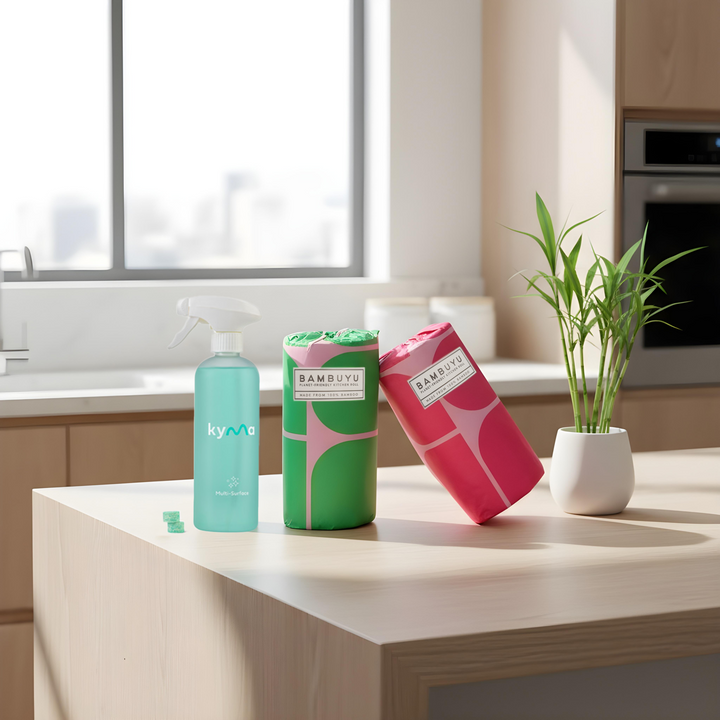 Kyma × Bambuyu The Clean Pair set with Kyma multi-surface cleaner and Bambuyu reusable towels on a kitchen counter. The eco-friendly home cleaning kit