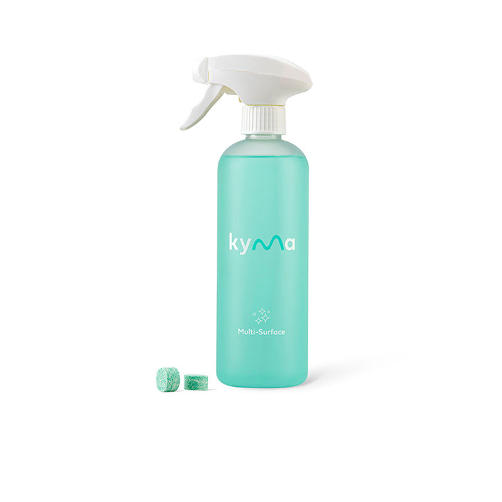 Kyma Multi-Surface Cleaner bundle featuring a turquoise refillable spray bottle and eco-friendly refill tablets stacked beside matching teal packaging boxes labeled “Multi-Surface non-toxic cleaner.”