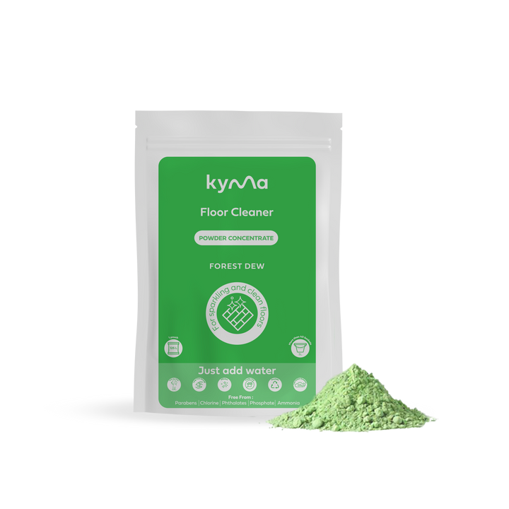 Kyma Floor Cleaner in Forest Dew variant, featuring an eco-friendly powder concentrate pouch with natural green cleaning powder beside it designed for sparkling, chemical-free floors with a refreshing scent.